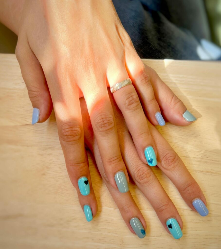 Manucure institut mobile Onglerie : Pose de vernis semi-permanent bleu et vert d'eau avec nail art petits cœurs